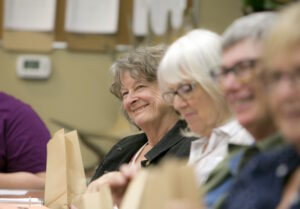 Smiling volunteer board members at meeting